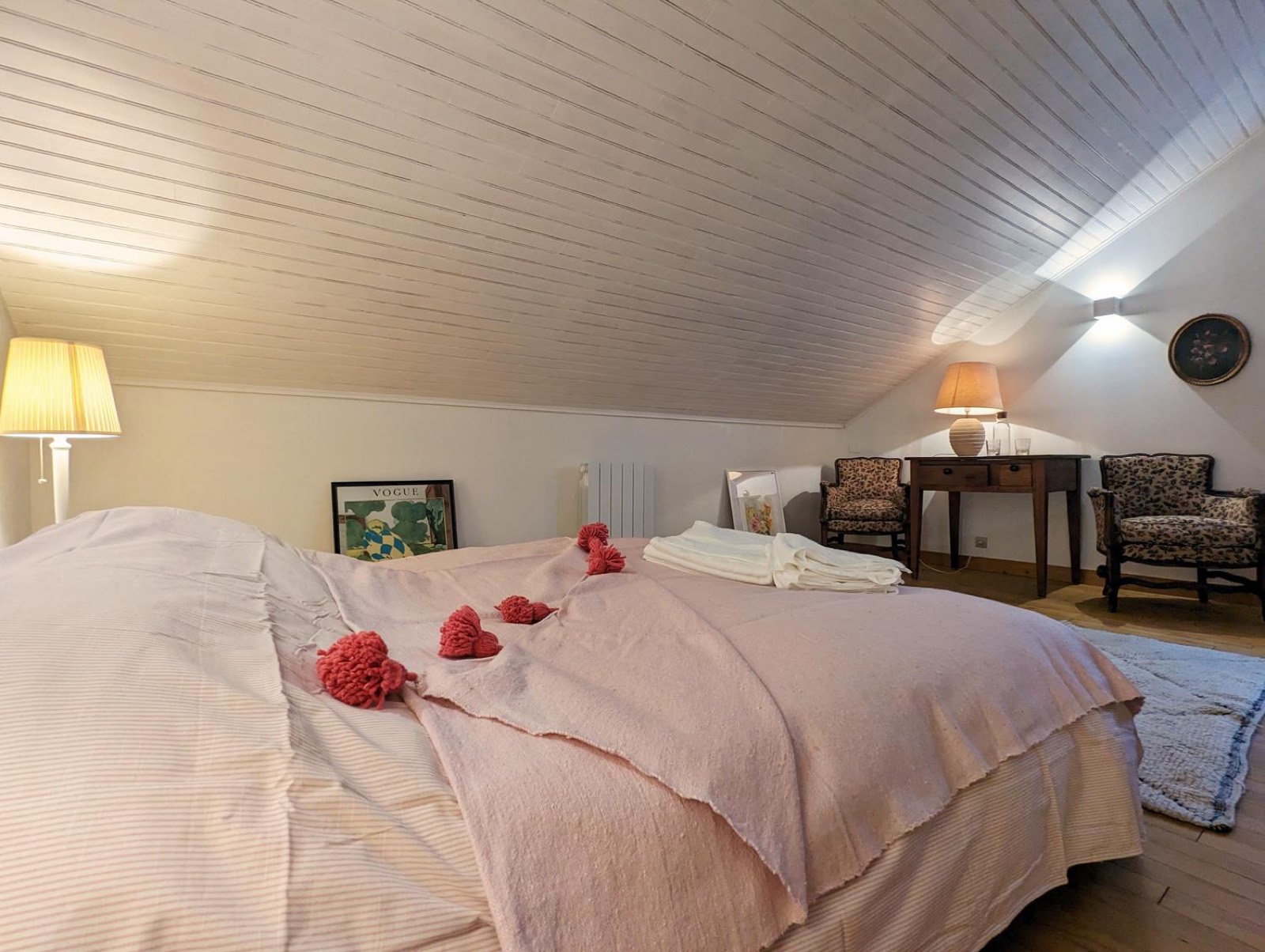 Attic bedroom with pink bedspread