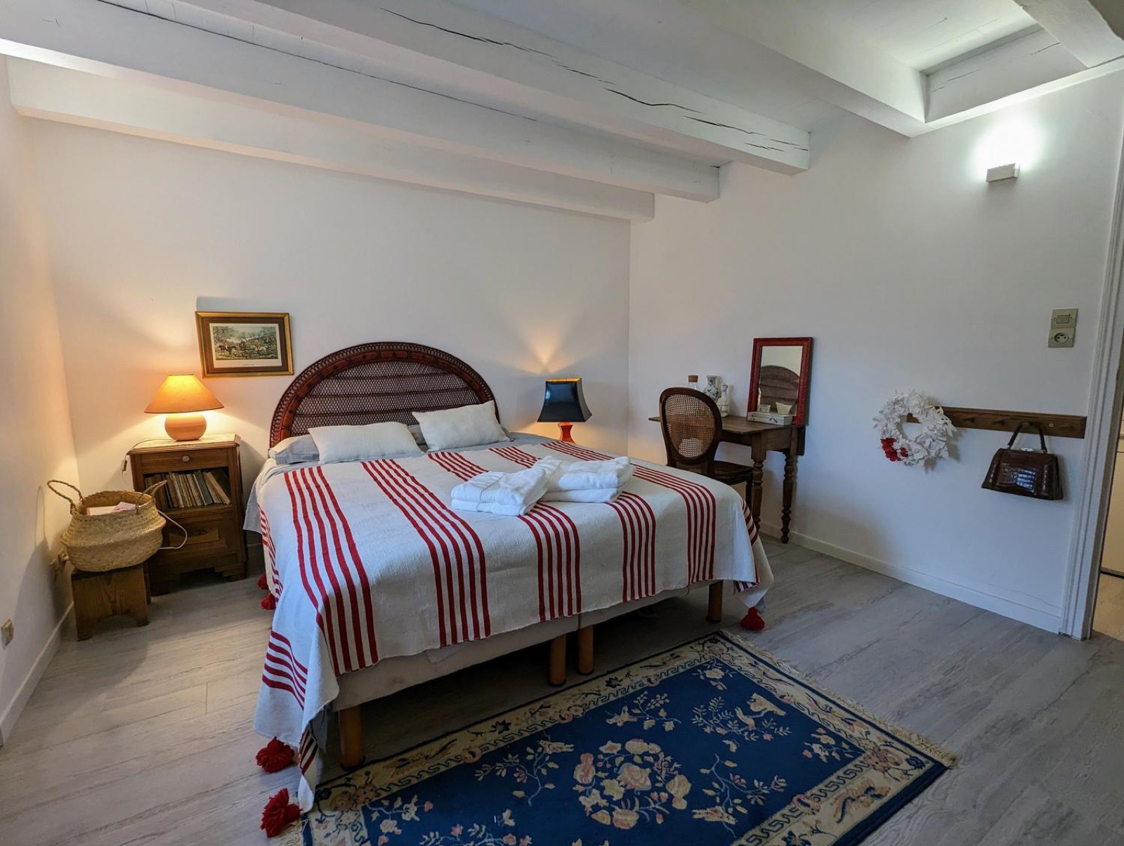Bedroom with wicker headboard and red and white linen