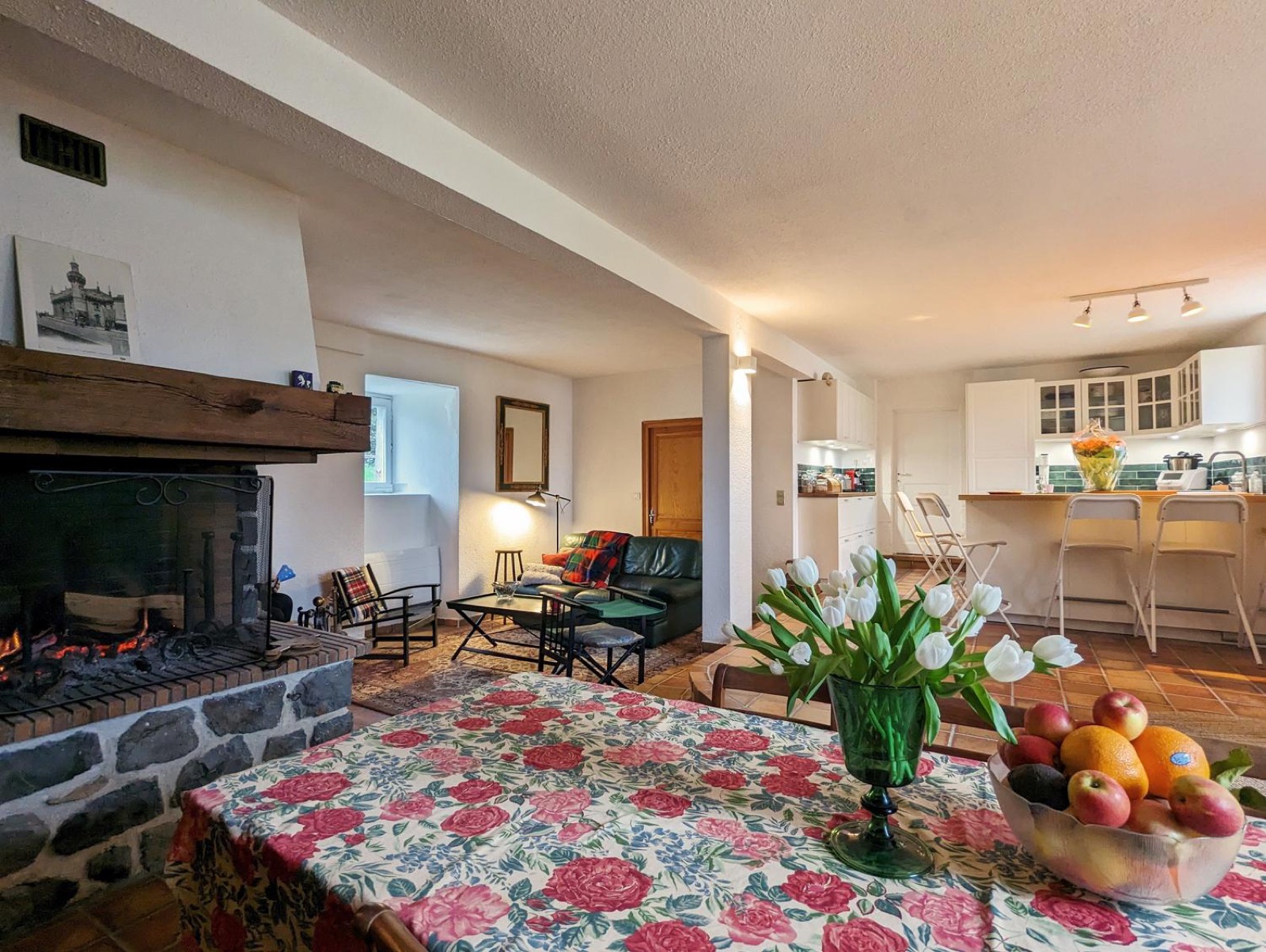 Open-plan living area with kitchen and stone fireplace