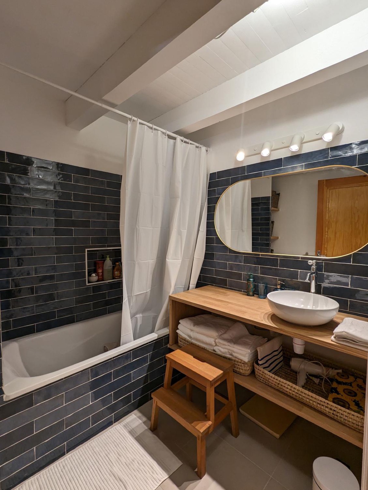 Bathroom with bathtub and blue tiling