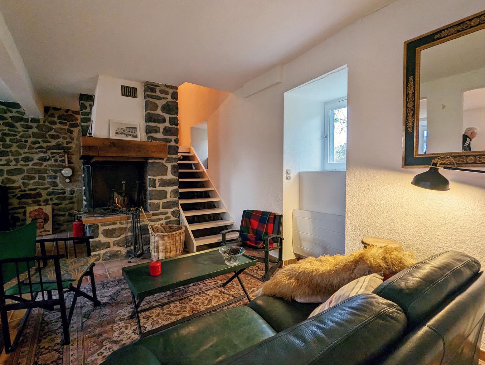 Living room with stone and wood staircase