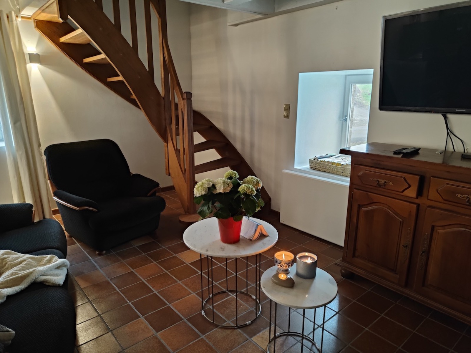 Sitting area with television and staircase